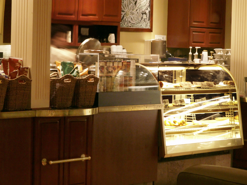 Counter,In,Coffee,Bistro,With,Bagels,Under,Glass,And,Busy Cafe Stock Under